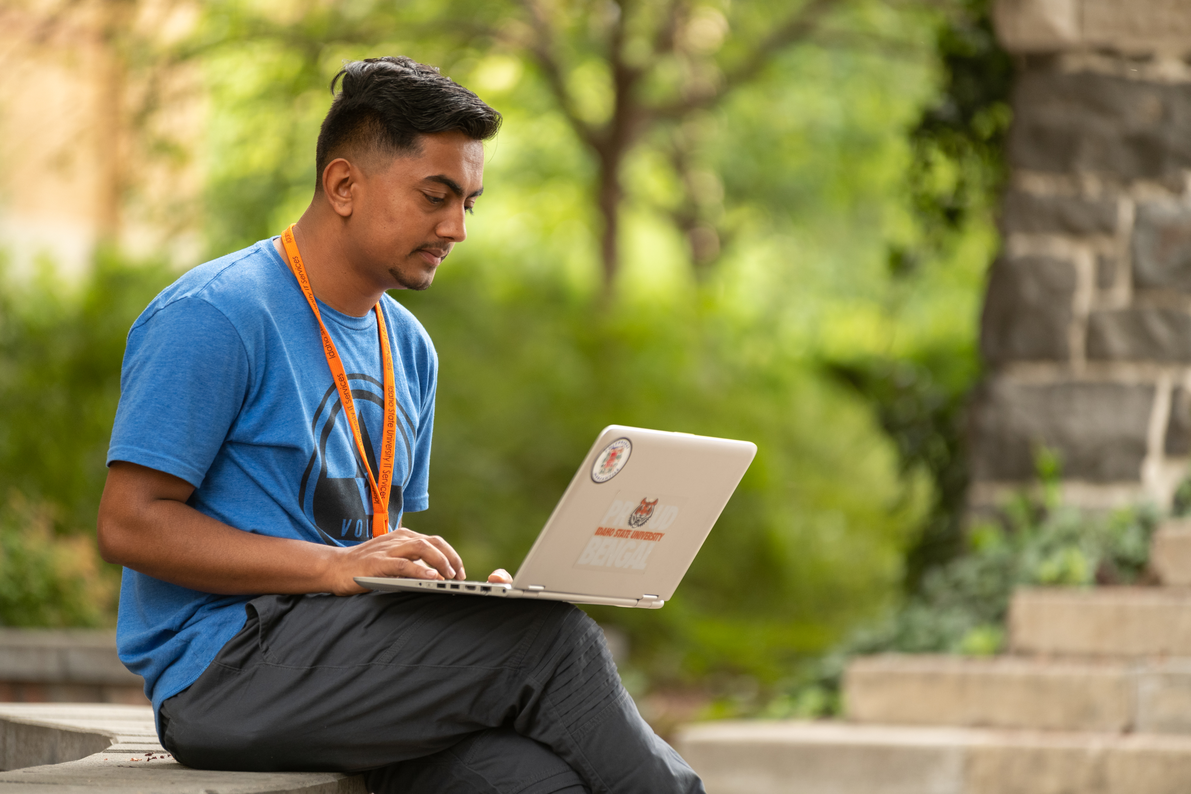 Student using a laptop outdoors.