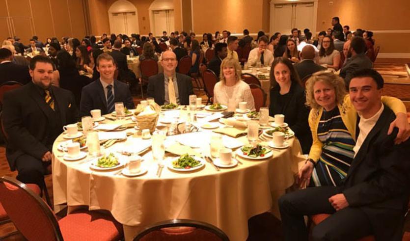 Students sitting at table at awards dinner