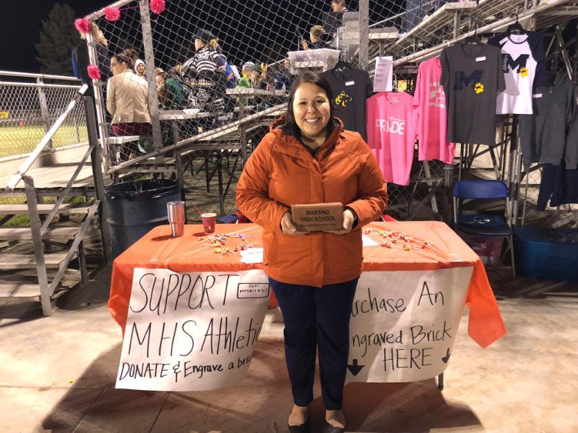 Student Angela Pierce standing in front of table