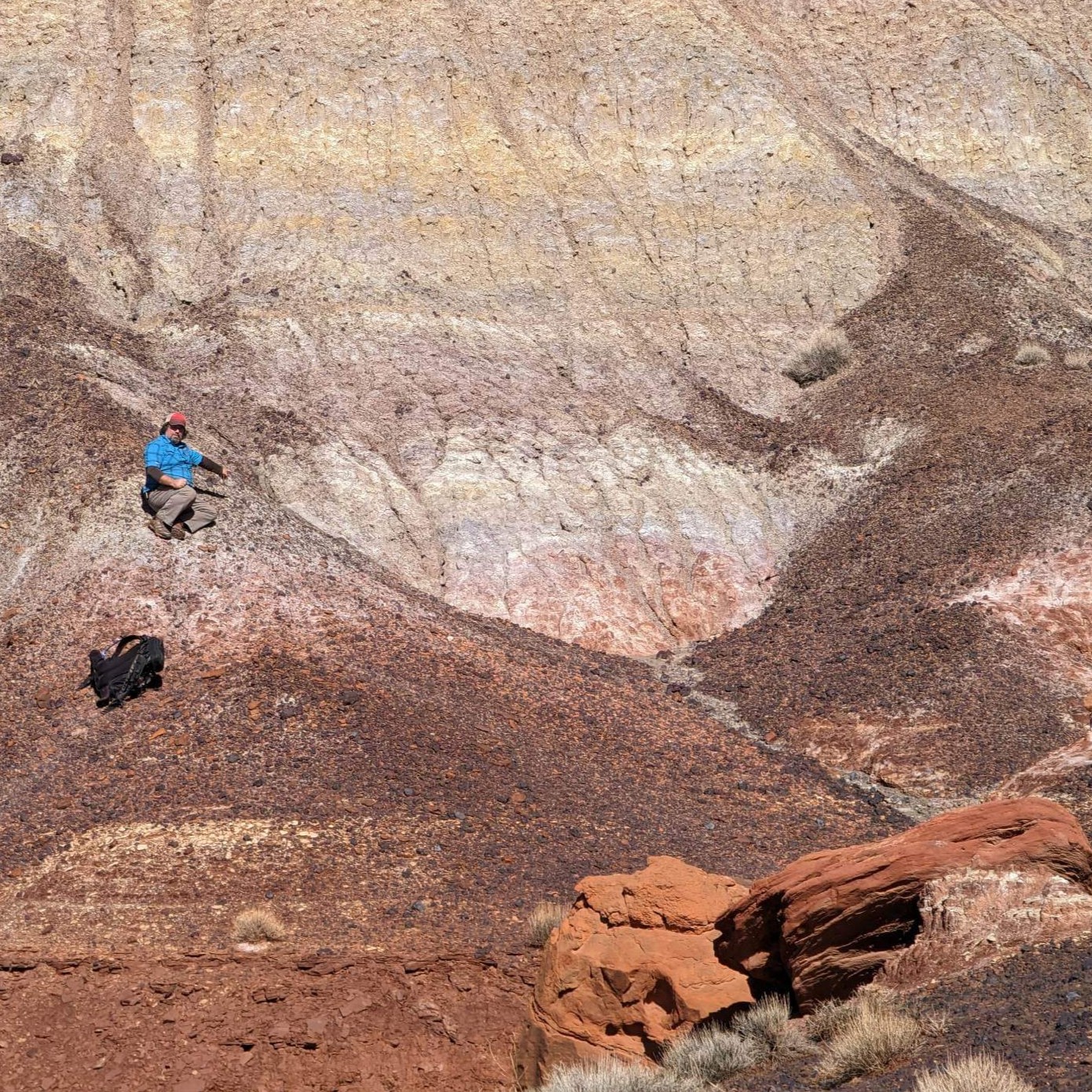 Red landscape with a man in blue shirt in background