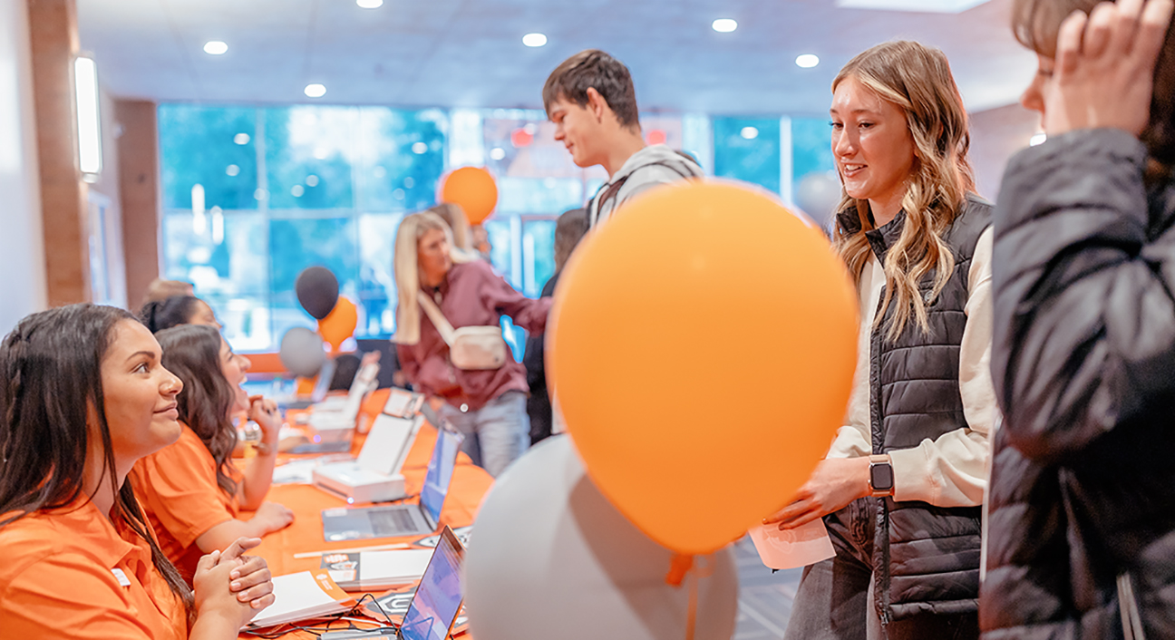 Students speaking with staff at an NSO event