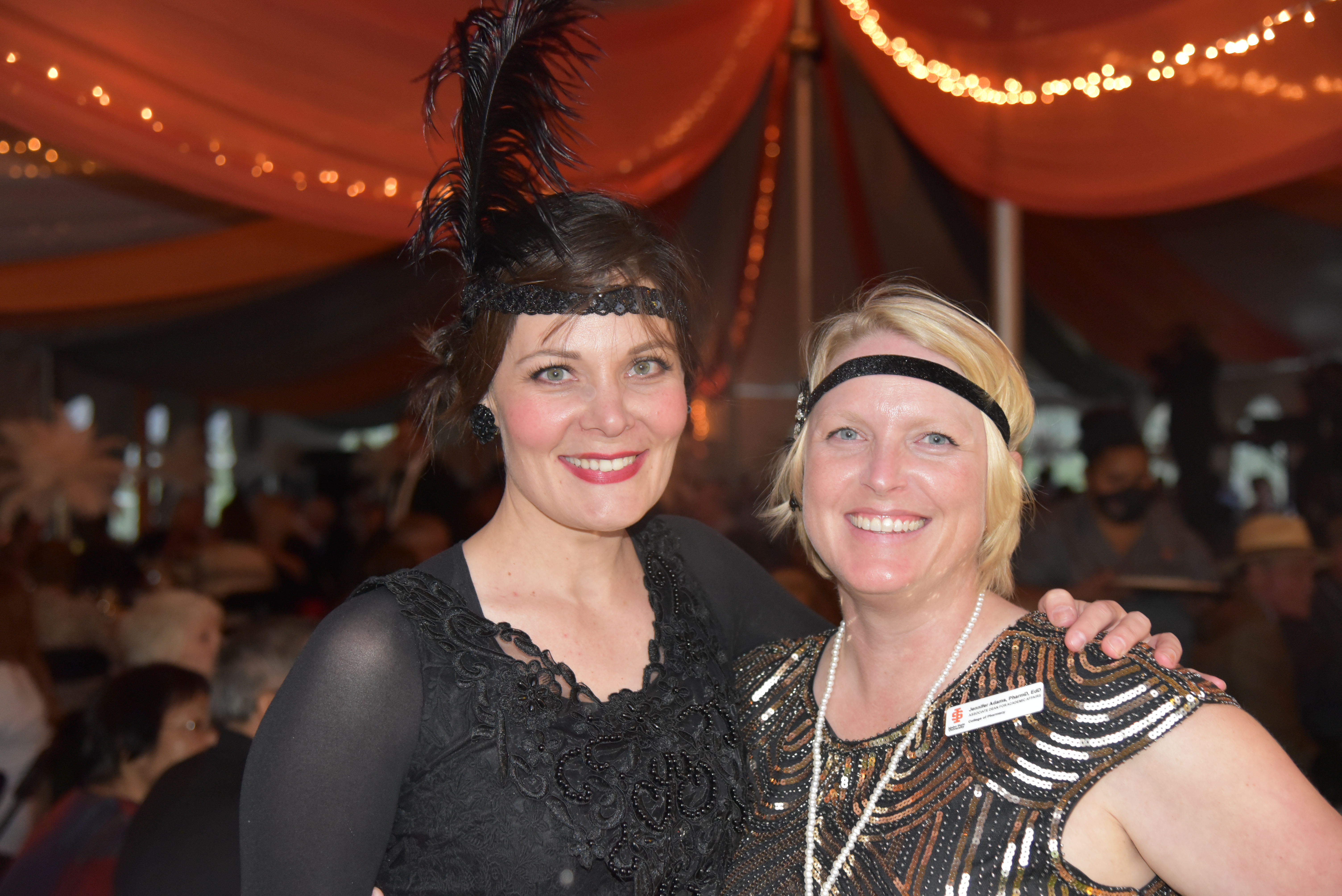 Attendees celebrate in 20s themed dresses at the COP Centennial Celebration