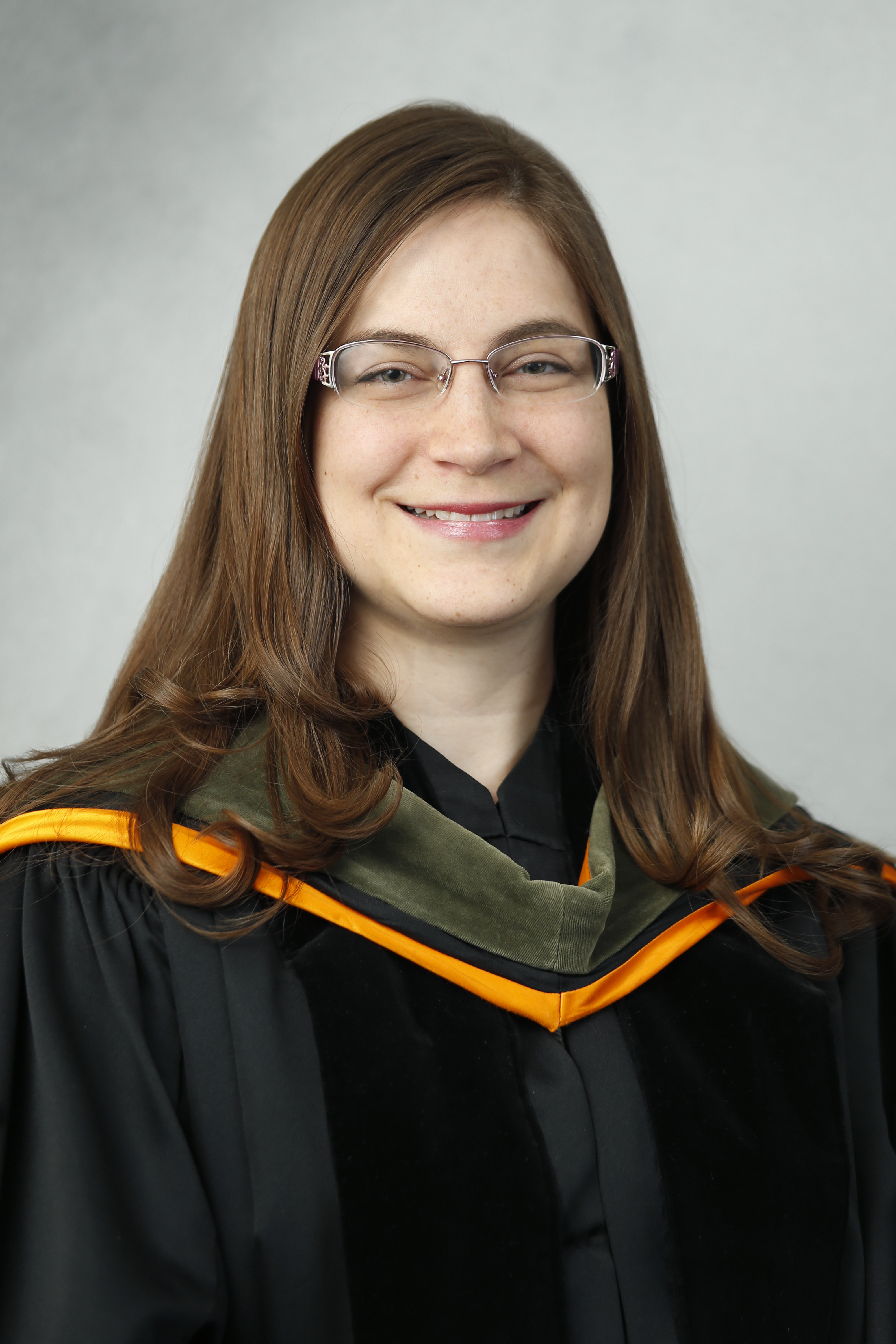 Janelle Solbos in commencement regalia