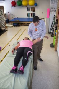 A lady getting physically therapy done on her arm