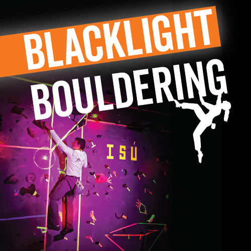 A student climbs the rock wall under blacklight