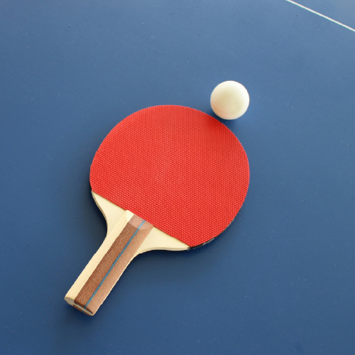 Table Tennis Paddle and Ball on a table