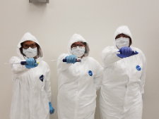 researchers in bunny suits for the DNA lab