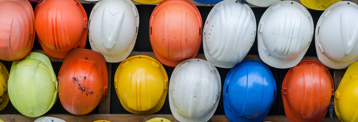 Rows of multi-colored construction helmets