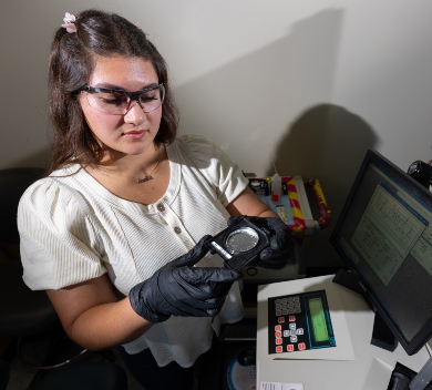 Student holding sample