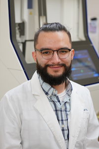 Portrait image of a CPI Student in front of Sanger sequencer