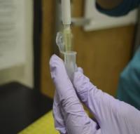 Researcher pipetting a sample into a microcentrifuge tube