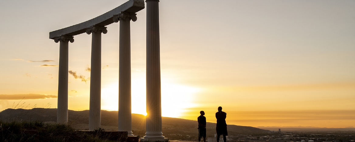 The pillars on Red Hill with the sun setting behind them