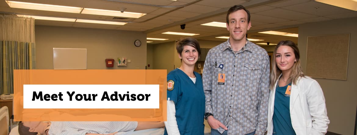 2 female nursing students standing on either side of a male instructor