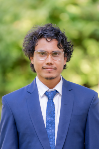 Headshot of Subash Pandey with green leaves in the background