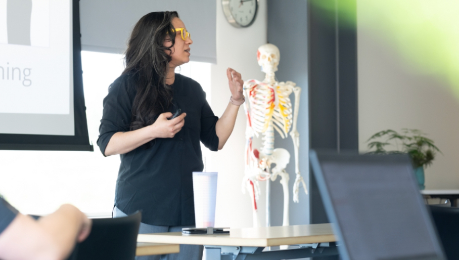 Health professional presenting using an anatomical model at a North Idaho AHEC continuing education event.