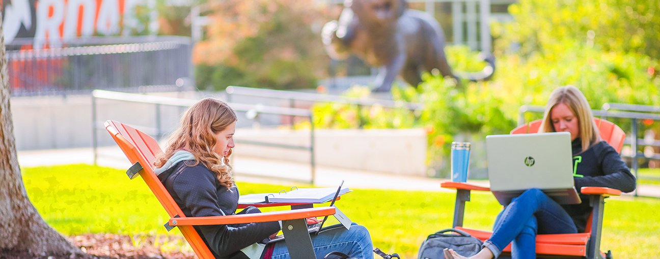 Two students working on homework at the Quad