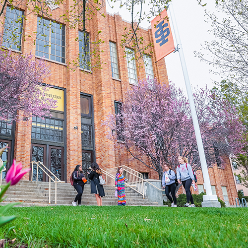 Students walking in front of Gravely Hall in Spring