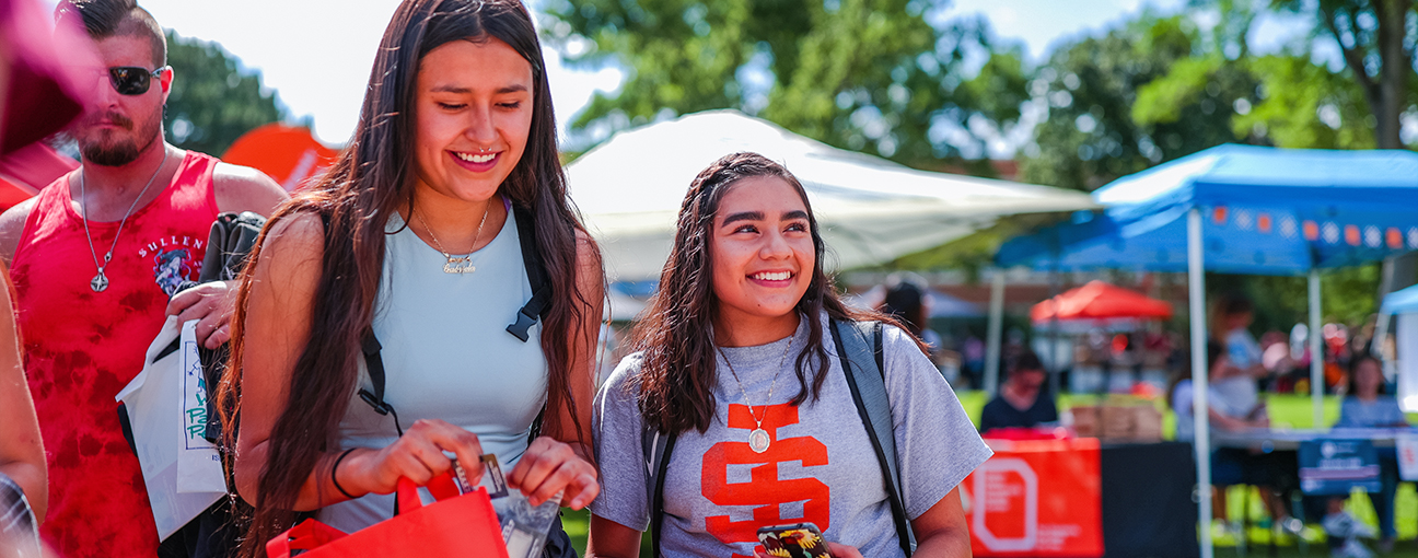 Two students in ISU T-shirts outdoors