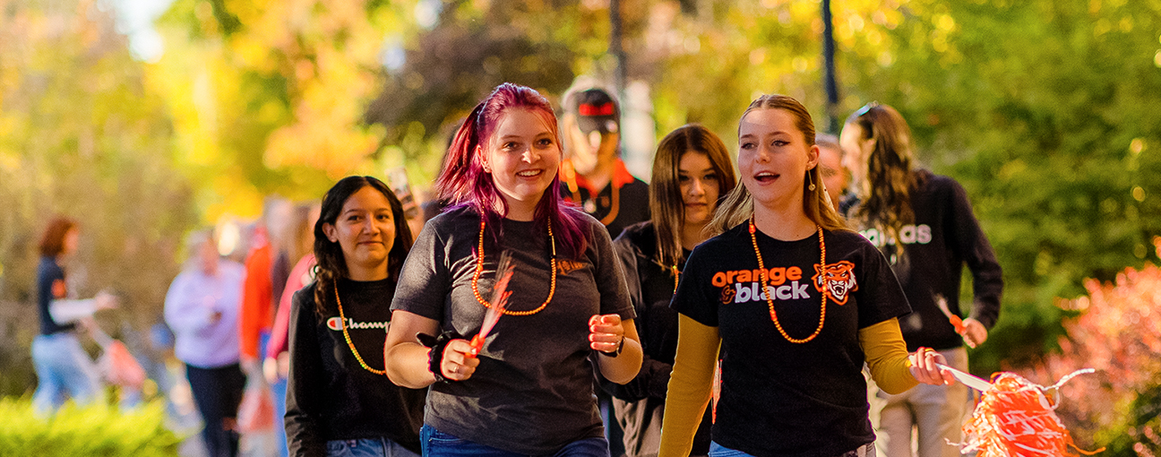 A group of students in ISU t-shirts outside in Autumn