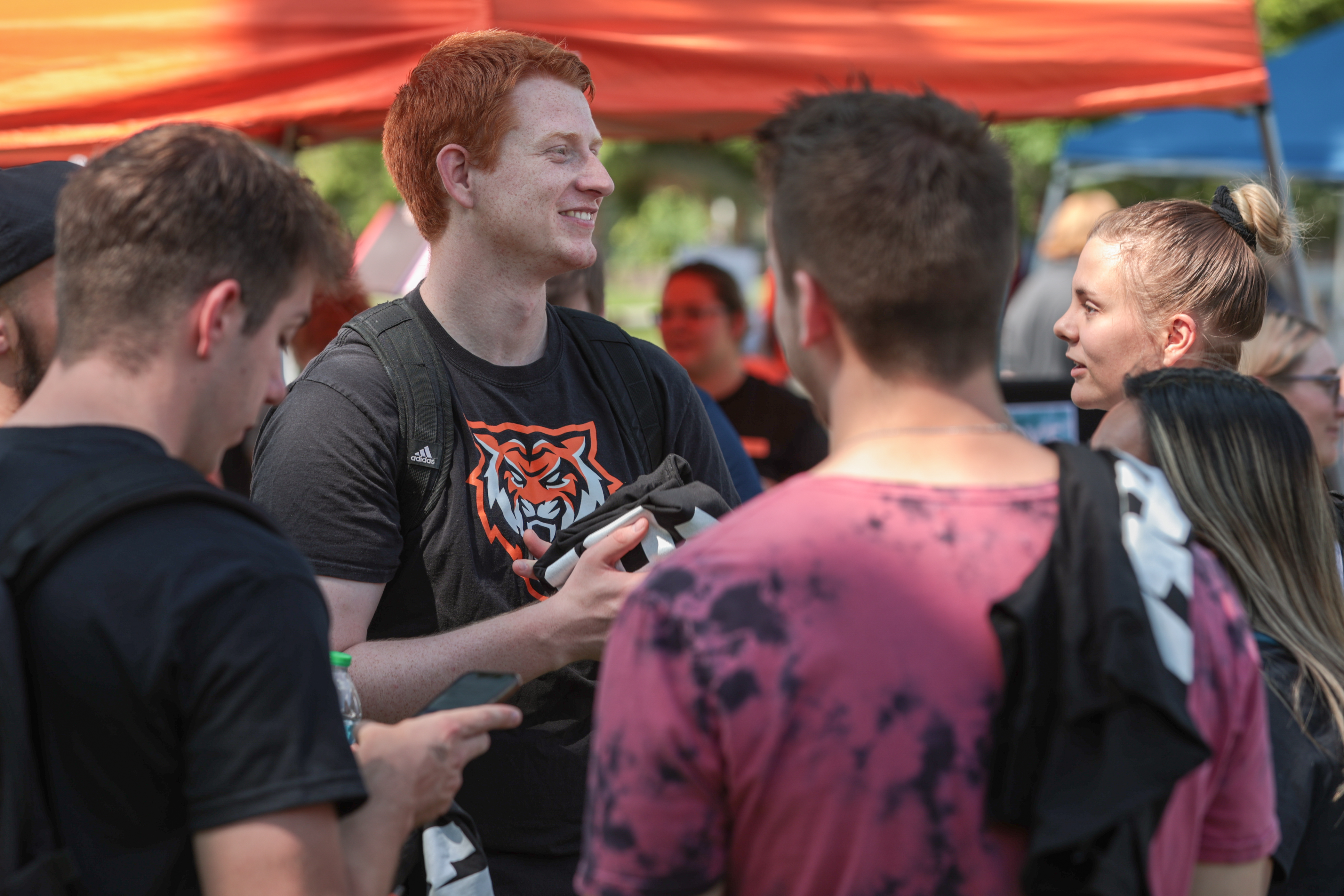 A group of students outside, smiling.