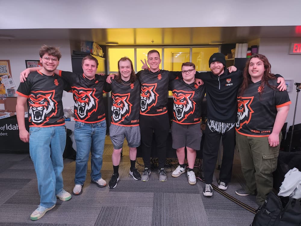 Post-tournament picture of our full Valorant team smiling and embracing together