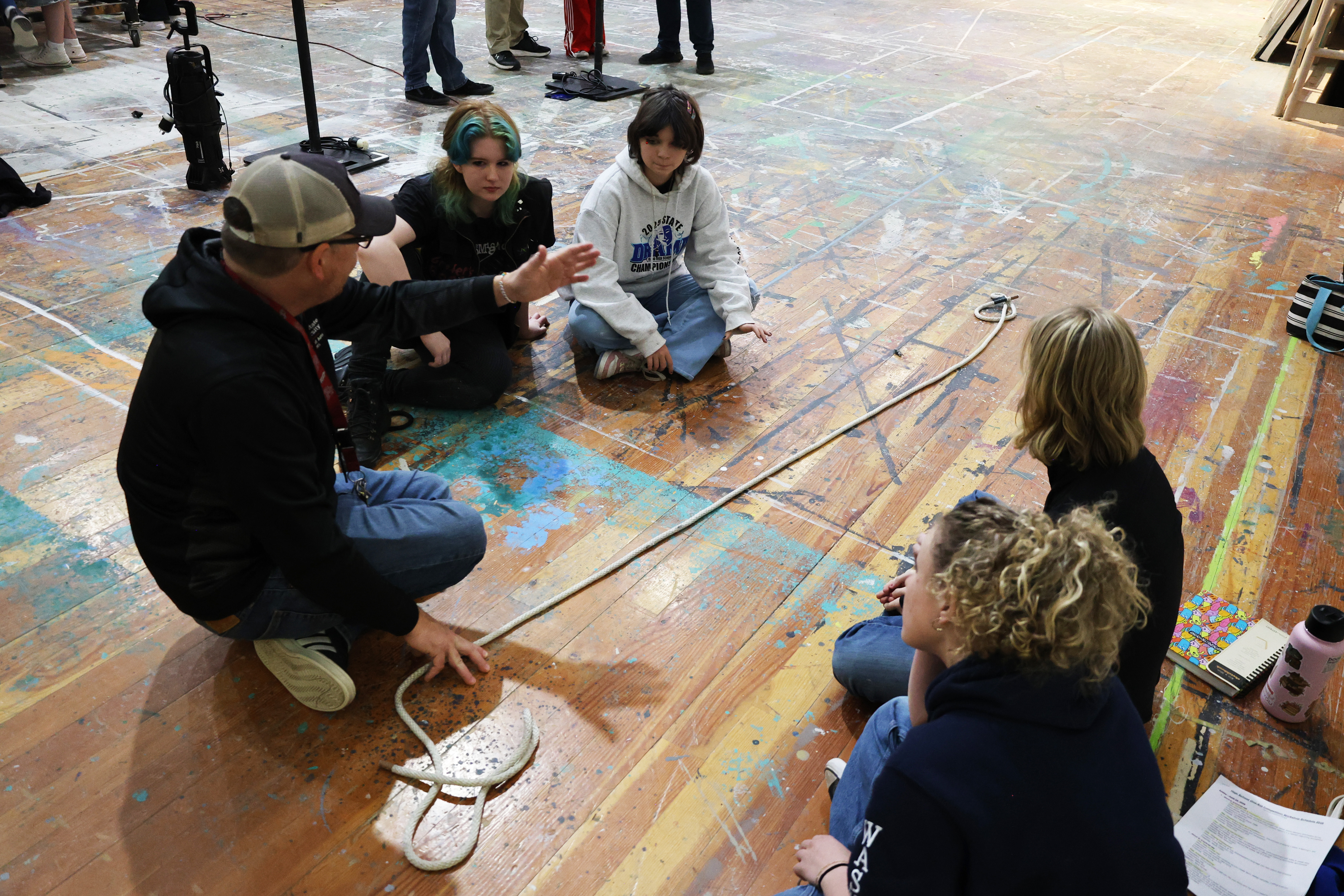 Faculty teaching students in the theatre scene shop