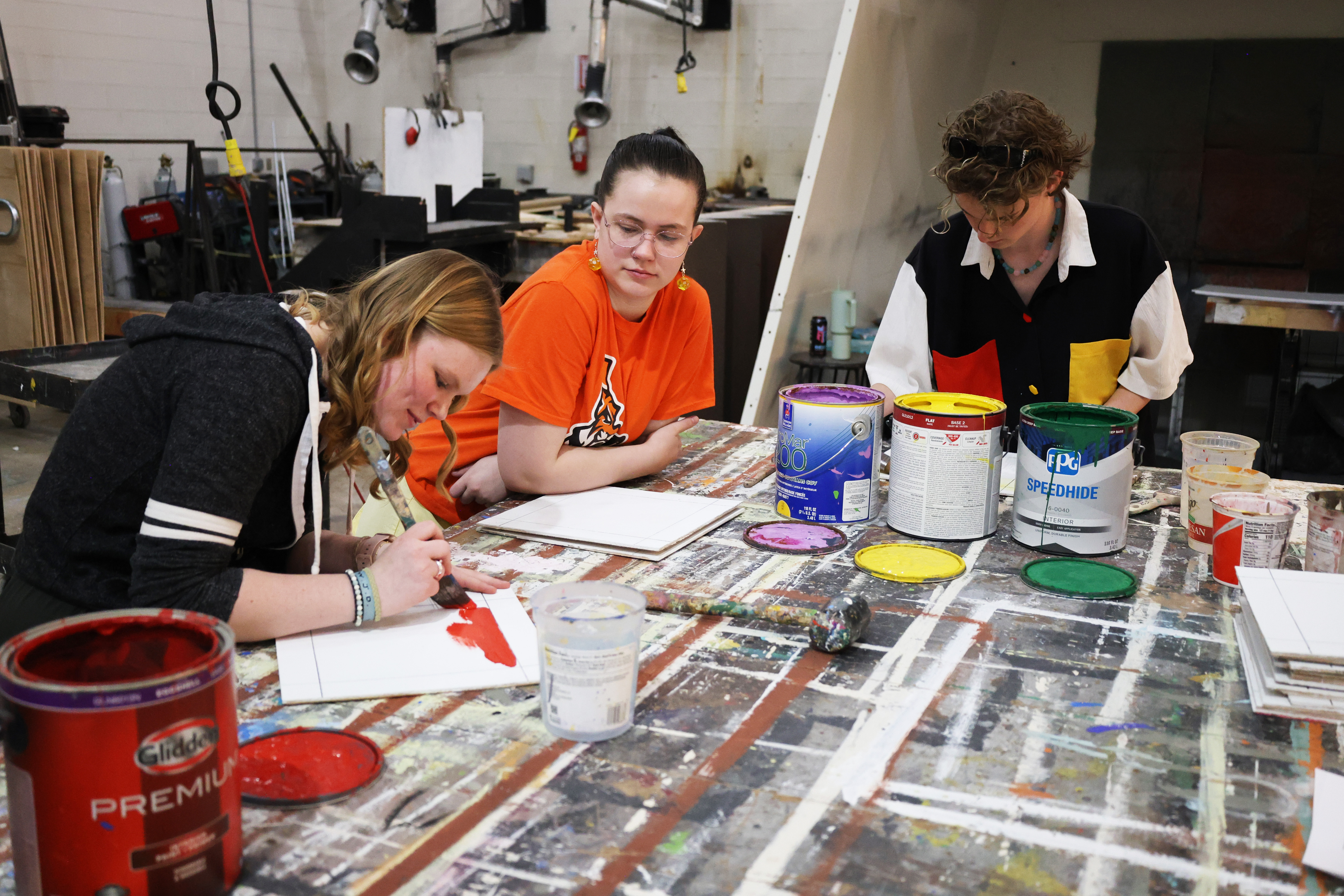 Students painting in the theatre scene schop