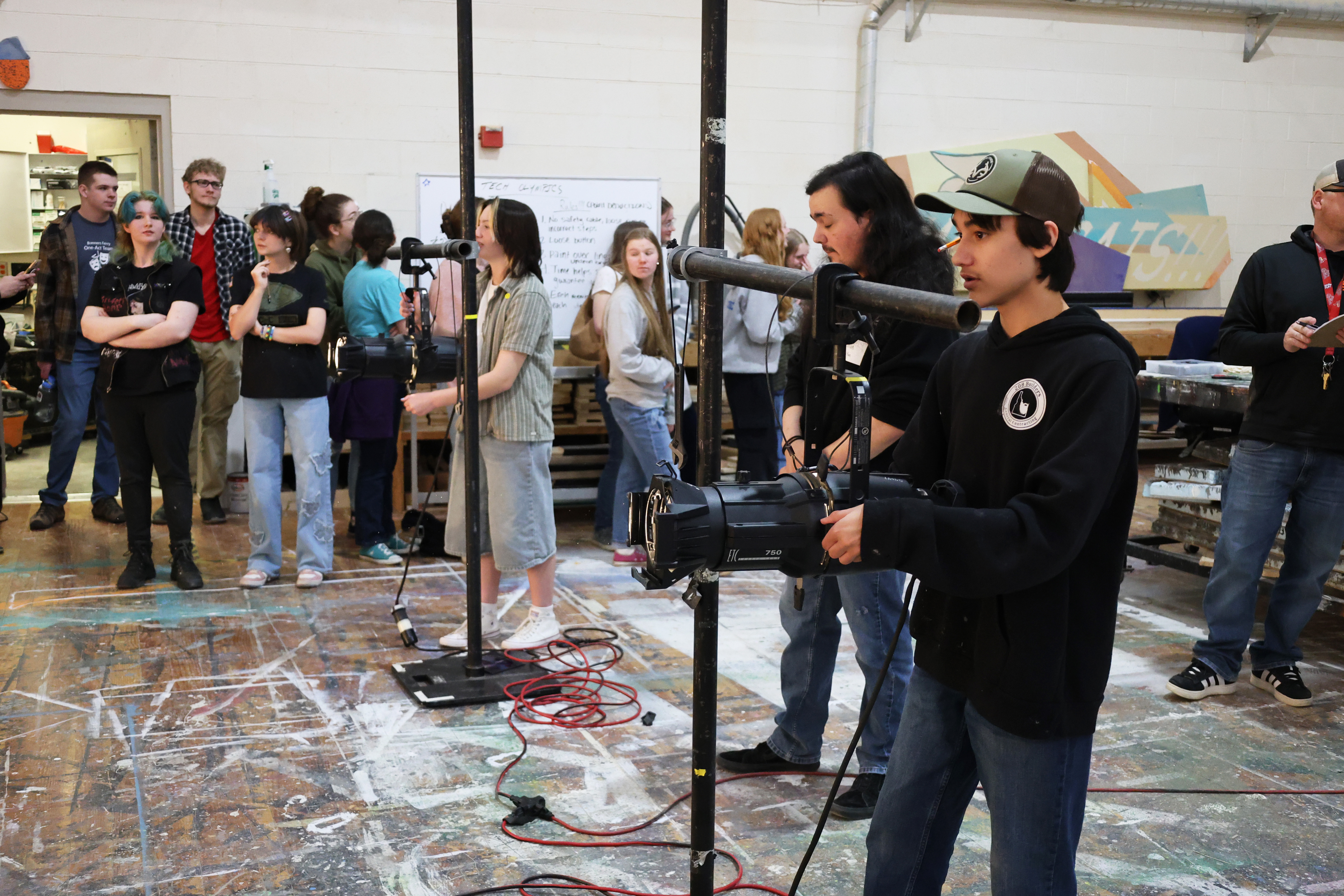 Students doing lighting work in the scene shop