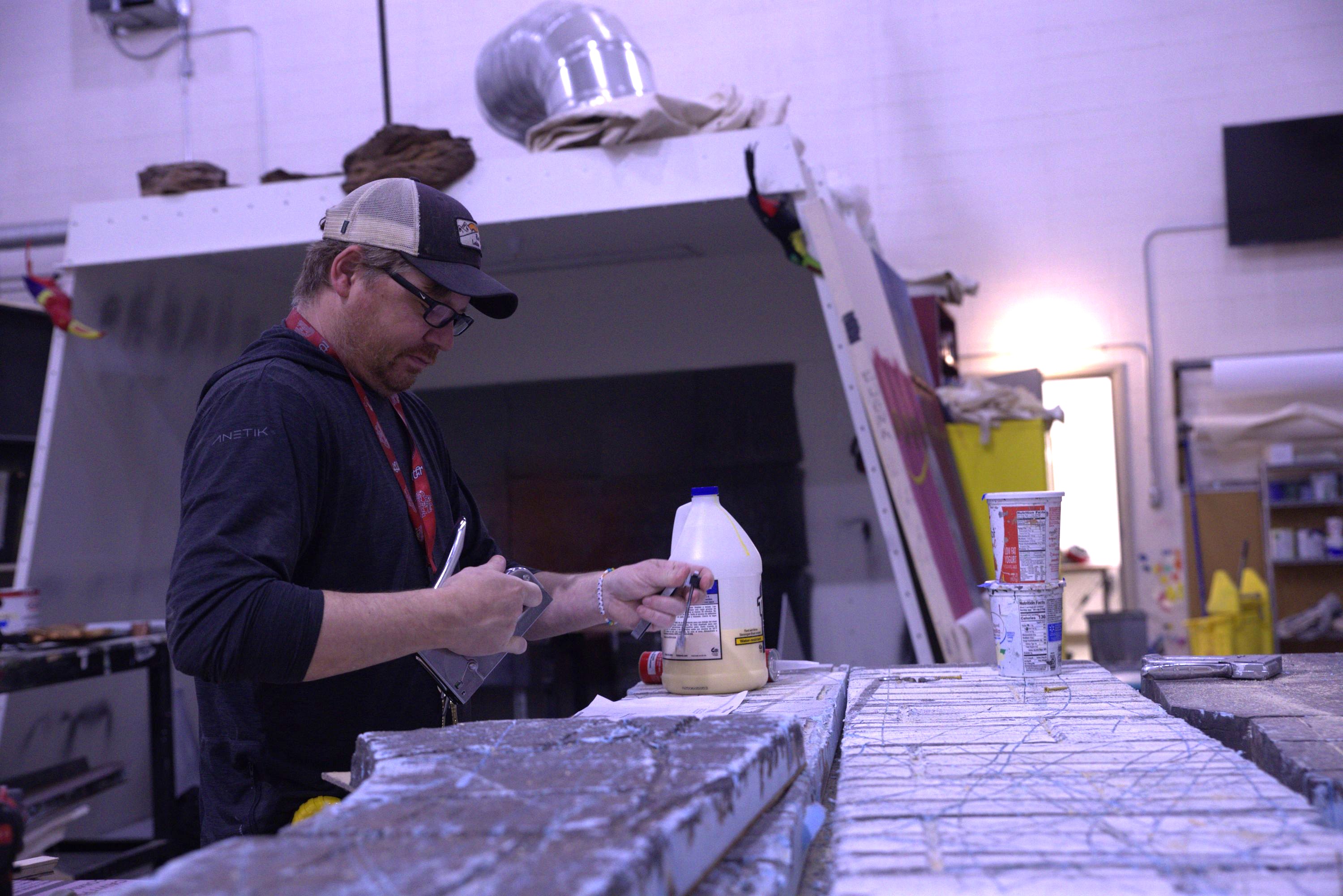 Faculty member doing work in the theatre scene shop