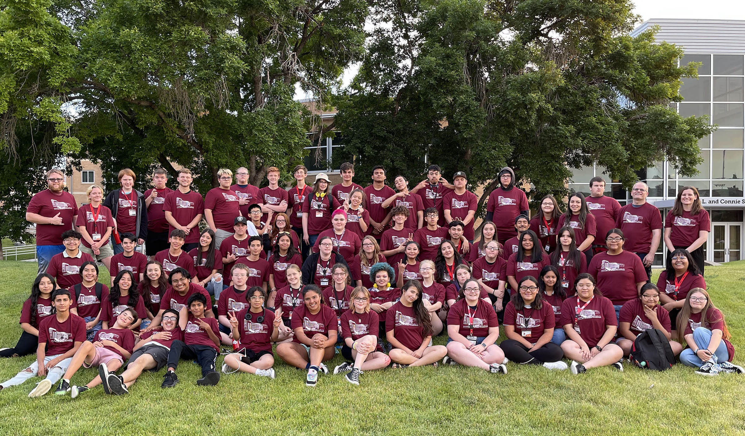 Upward Bound Programs students in matching t-shirts on a grassy hill on the ISU campus for 2022 summer program