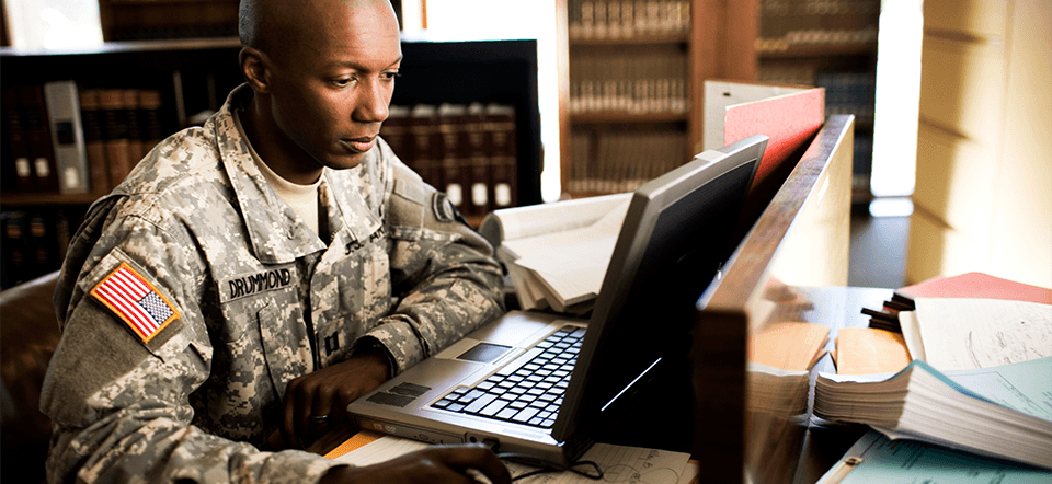 Student studying with a laptop at in a library.