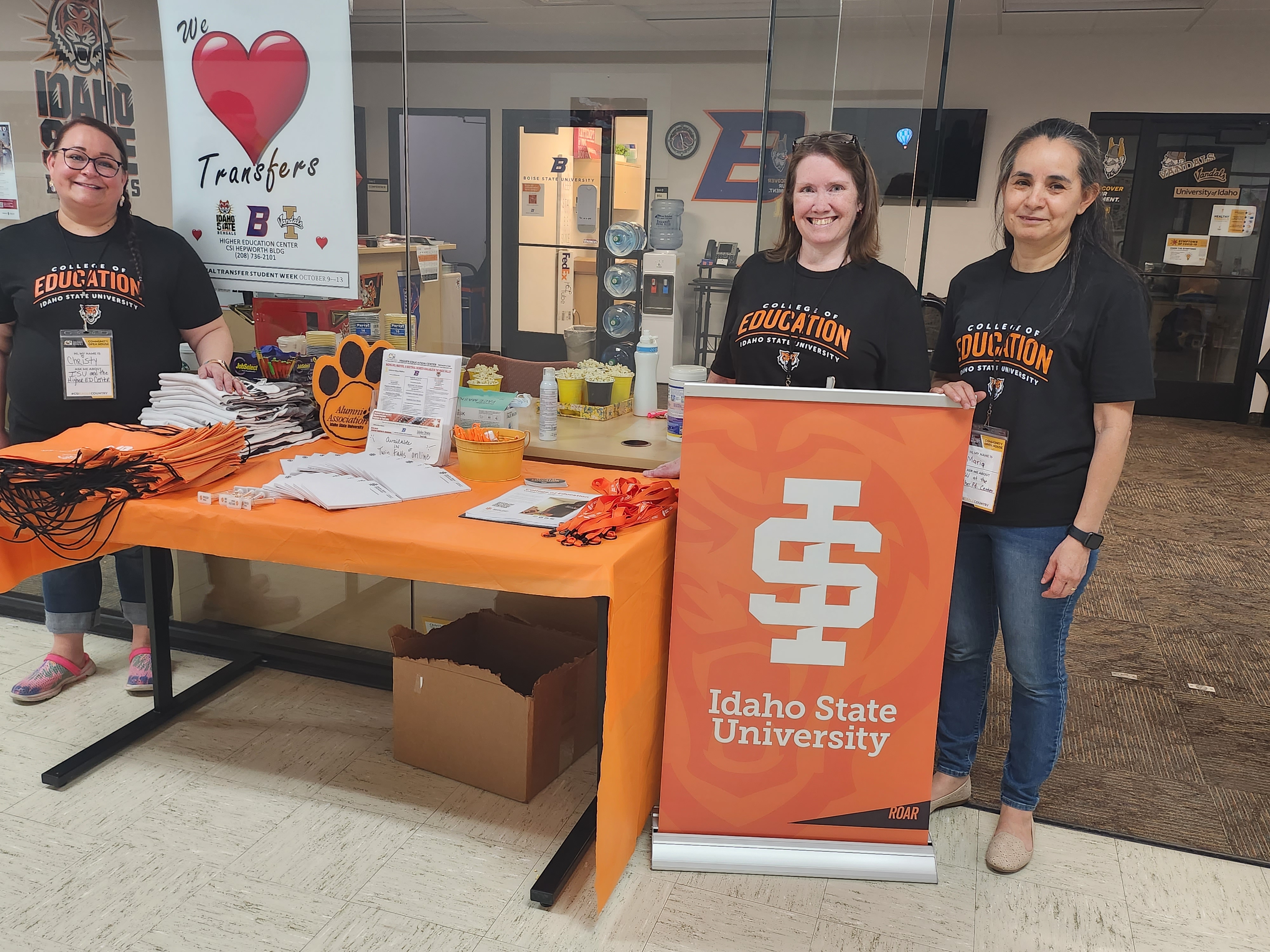 Picture of ISU staff behind an open house table.