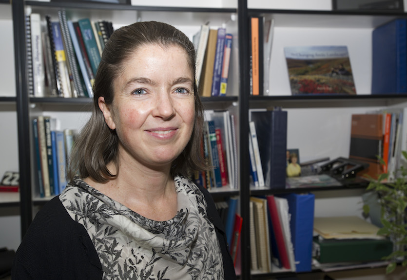 Photo of Sarah Godsey with books in shelf in the background. 