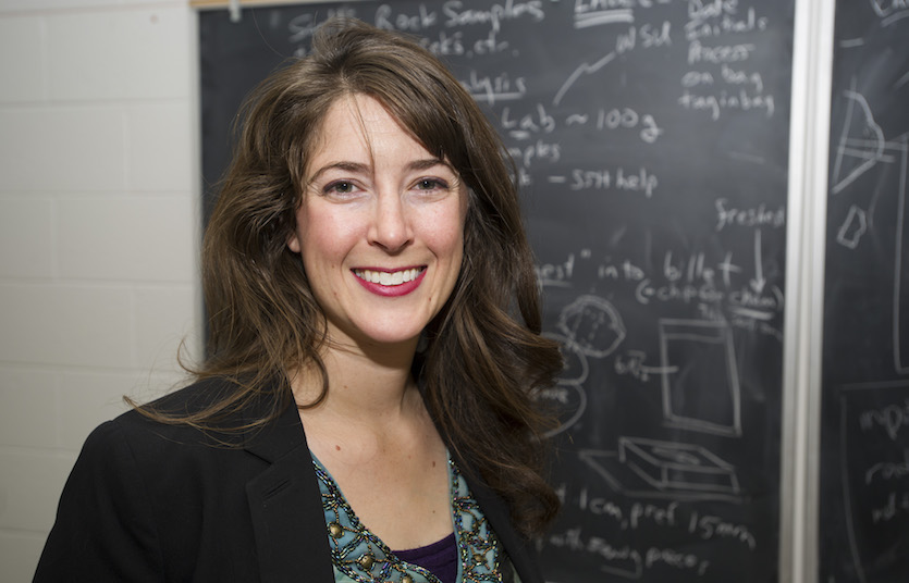 Portrait of Shannon Kobs Nawotniak with blackboard in the background.