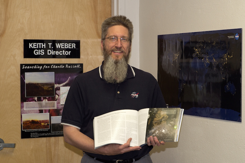 Keith Weber holding copy of NASA publication.