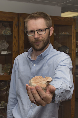 Leif Tapanila with termite mound fossil.