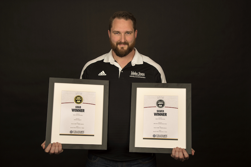 Videographer Martin Baker holding his Gold and Silver Award certicates