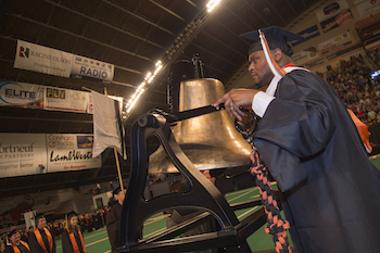 Craig Joseph ringing bell at commencement