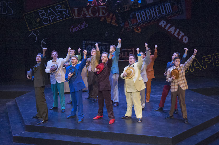 A photo of castmembers in Guys and Dolls dancing on stage.