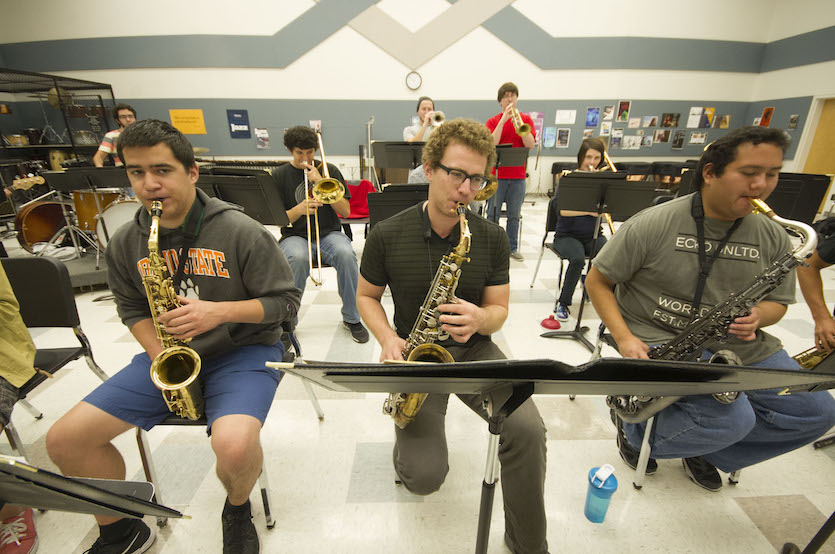 Jazz Band saxophone players in foreground, other members in background photo. 