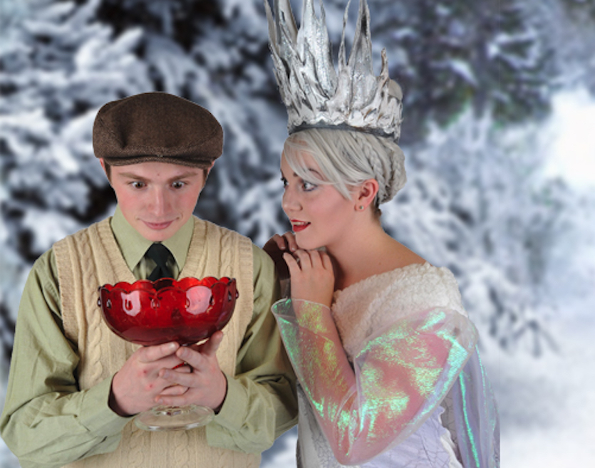 Two cast members on stage, a boy on the left and the queen on the right.