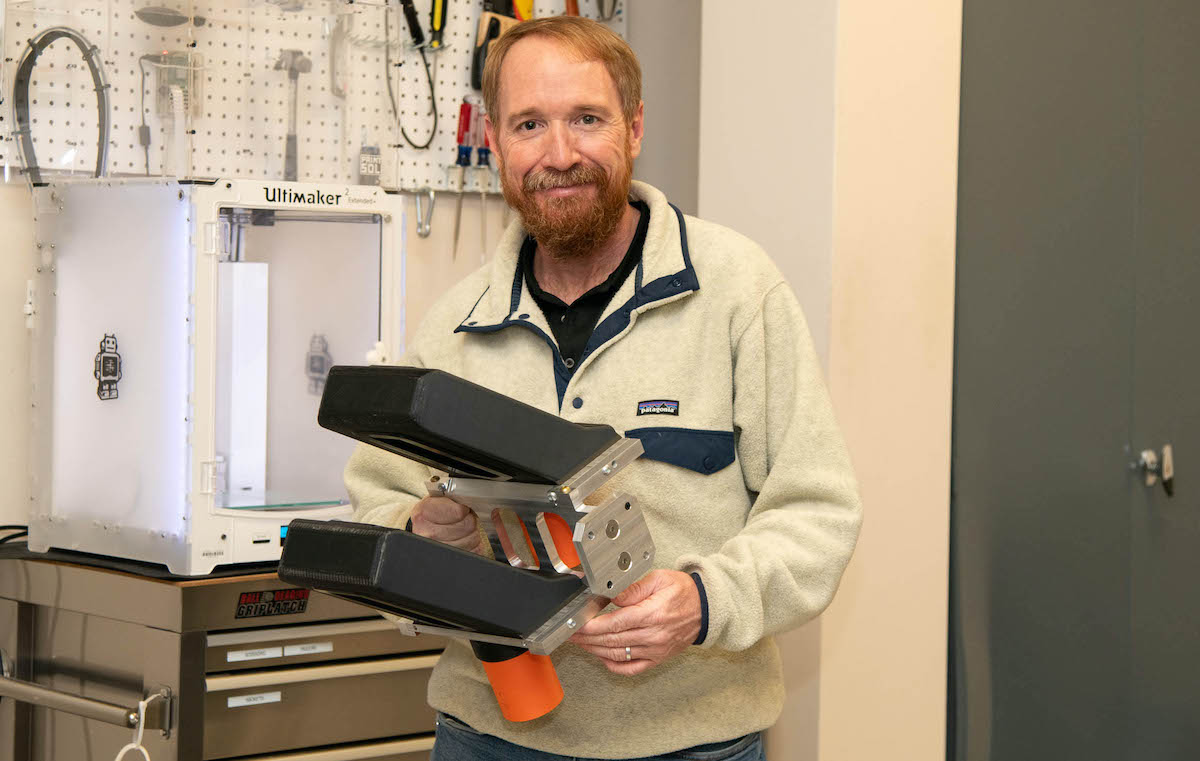 Idaho State University Professor Dustin McNulty holds a particle detector system created in his lab. The detector helped measure the neutron skin thickness of Calcium-48 to within .025 millionths of a nanometer.