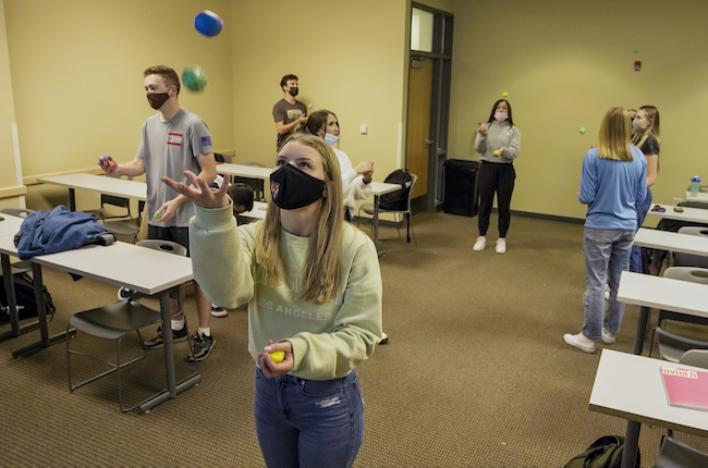 A group of students learning to juggle