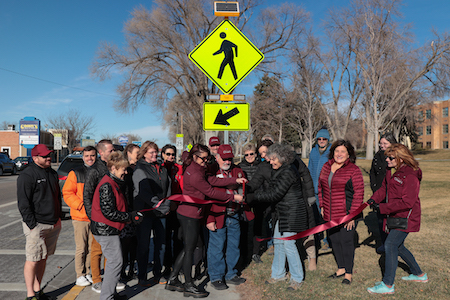 Members of the Chamber of Commerce standing by the crosswalk