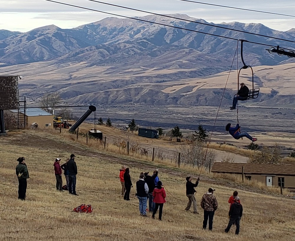 A group of ski patrollers practice skills.