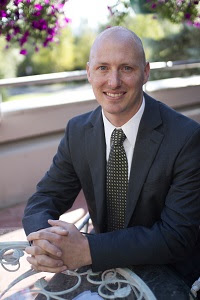 Joshua Swift sitting at a table smiling