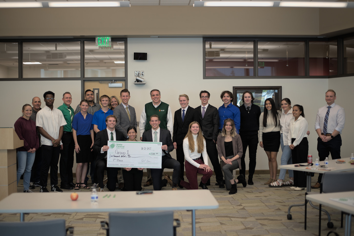 A group of students holding a giant check