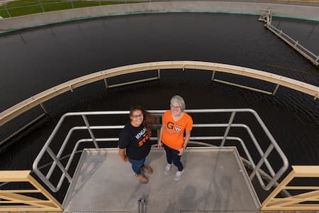 Julia Martin, associate professor of microbiology and biochemistry, left, and Emily Baergen, biology specialist at Idaho State University, pose for a photo at the City of Pocatello's Water Pollution Control Plant on Thursday, September 08, 2022. Martin and Baergen have started testing samples of wastewater collected at five water treatment facilities in East Idaho to look for COVID-19.