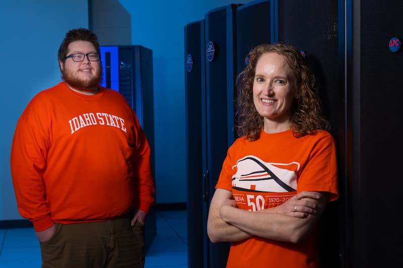 Michael Ennis, High Performance Computing Solutions Architect, and Kindra Blair, Research Systems Administrator, pose for a photo in front of Ragnarok in the Research Data Center at Idaho State University's Pocatello campus on Monday, September 19, 2022.