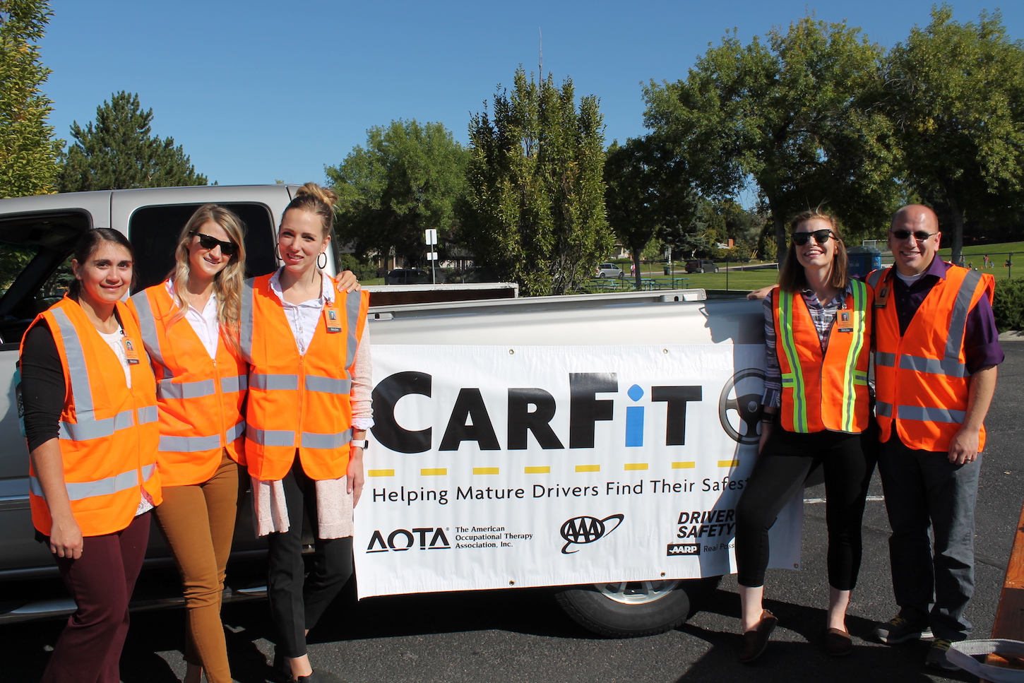 A group of students with a Carfit sign